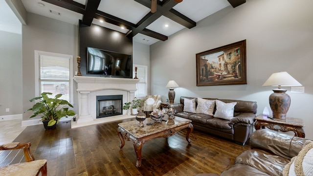 living room featuring beam ceiling, coffered ceiling, a towering ceiling, and dark hardwood / wood-style flooring