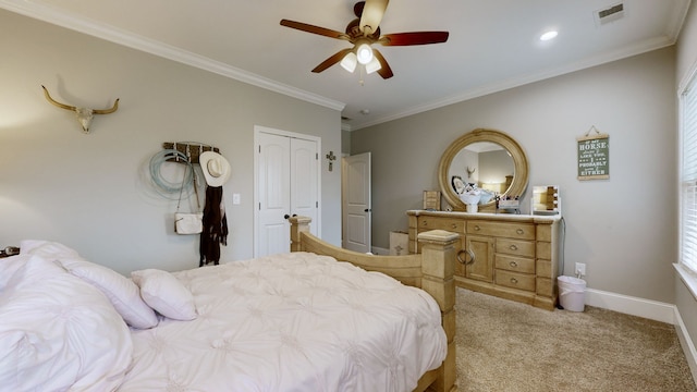 bedroom featuring a closet, ceiling fan, ornamental molding, and light colored carpet