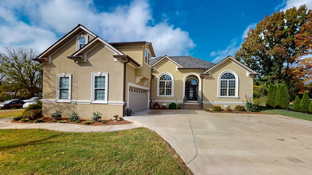 view of front of house with a front yard and a garage