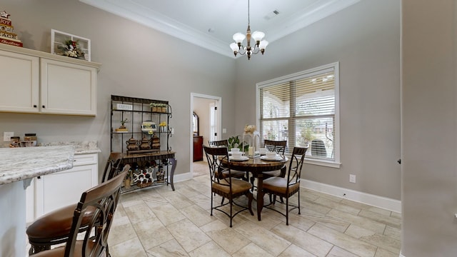 dining space featuring ornamental molding, an inviting chandelier, and a high ceiling