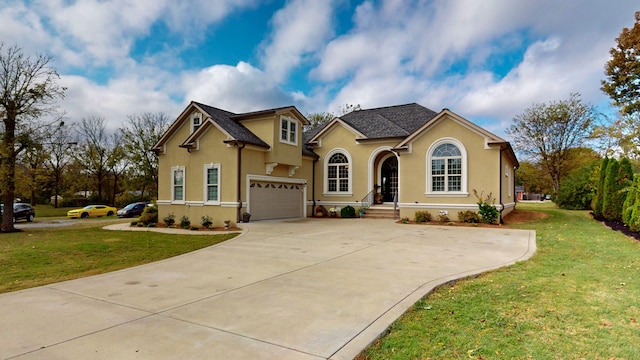 view of front of home featuring a front lawn and a garage