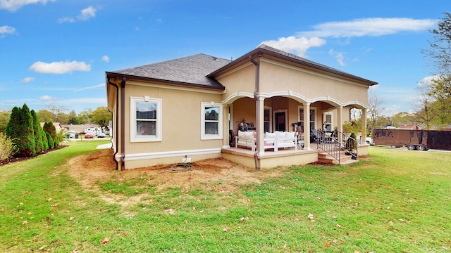 back of house with a yard and covered porch