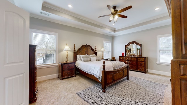 bedroom featuring ceiling fan, light carpet, ornamental molding, and a raised ceiling