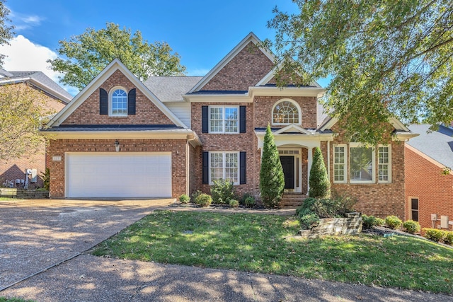 craftsman inspired home featuring a garage and a front lawn