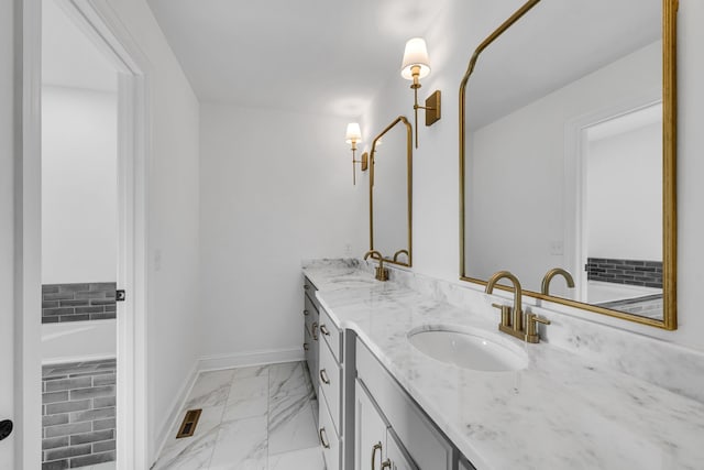 bathroom with vanity and a washtub