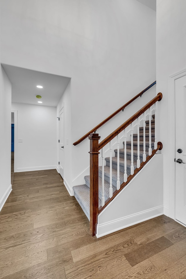 staircase featuring wood-type flooring