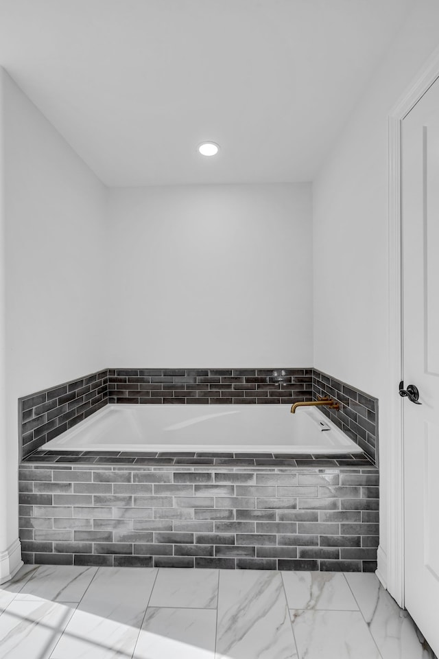 bathroom featuring tiled bath