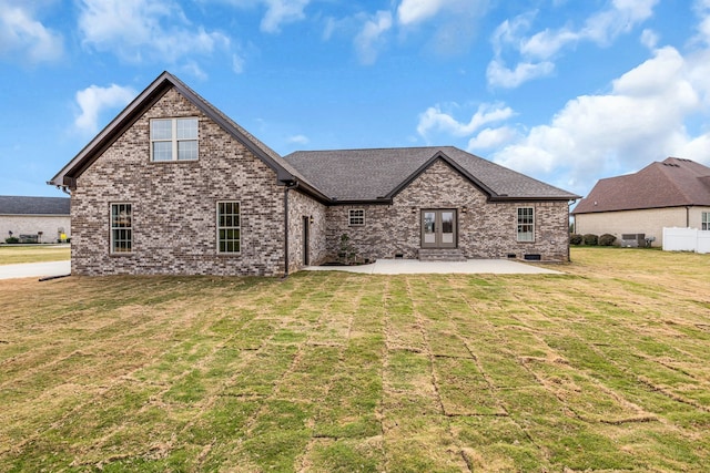 back of property with a patio and a lawn