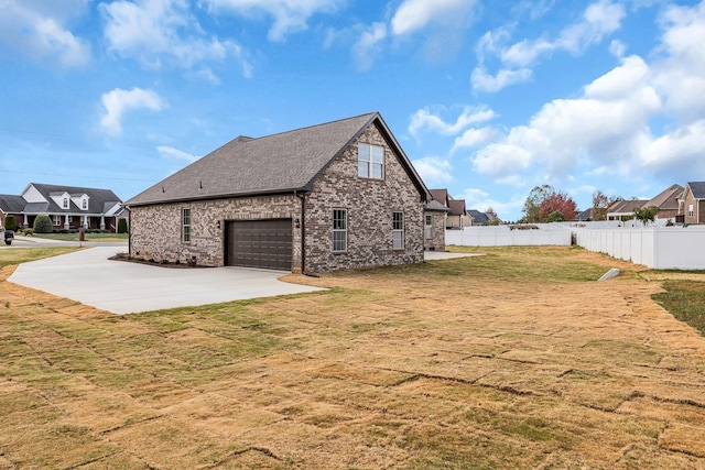 view of side of property with a yard and a garage