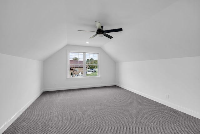 additional living space featuring vaulted ceiling, carpet floors, and ceiling fan