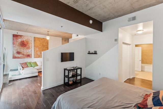 bedroom featuring connected bathroom and dark hardwood / wood-style floors