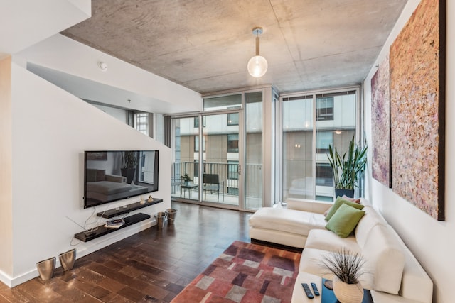 living room featuring dark wood-type flooring and a wall of windows