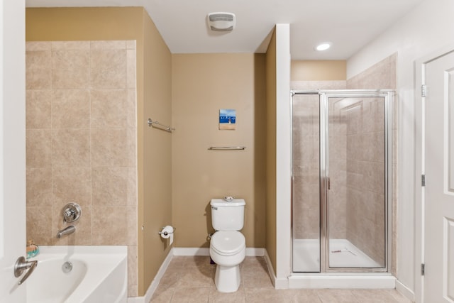 bathroom with toilet, plus walk in shower, and tile patterned flooring