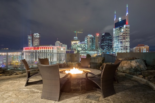 patio at night featuring a fire pit