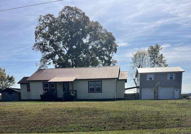 view of front of home with a front yard and a garage