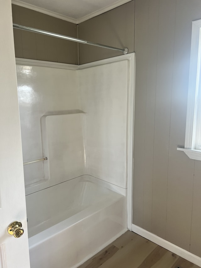 bathroom featuring wood-type flooring and shower / bathtub combination