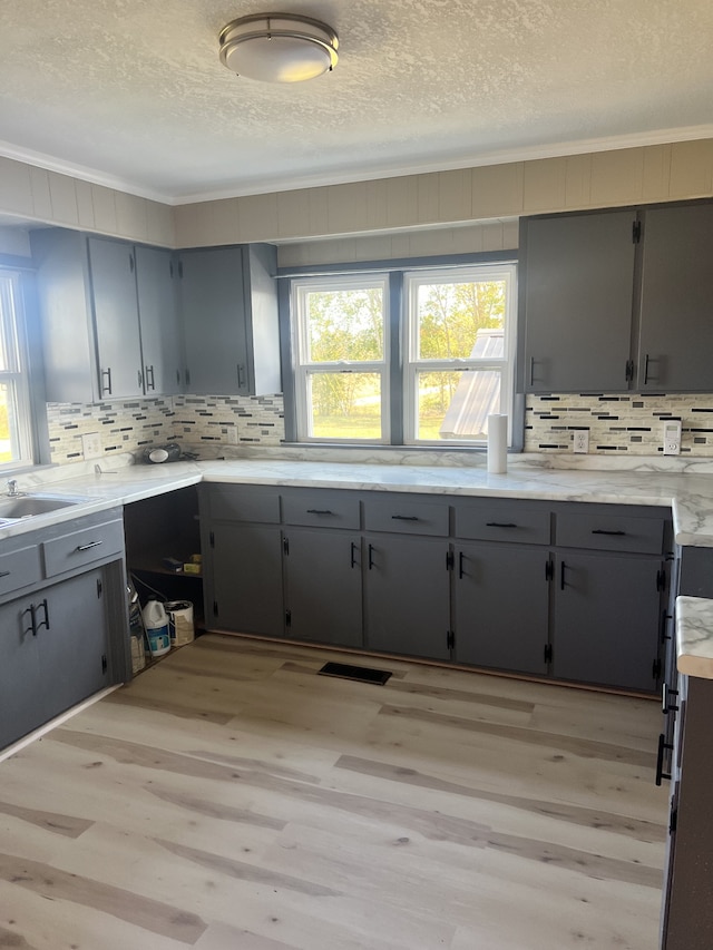 kitchen featuring gray cabinetry and light hardwood / wood-style flooring