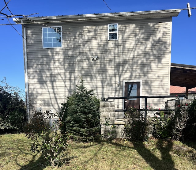 view of home's exterior with a lawn