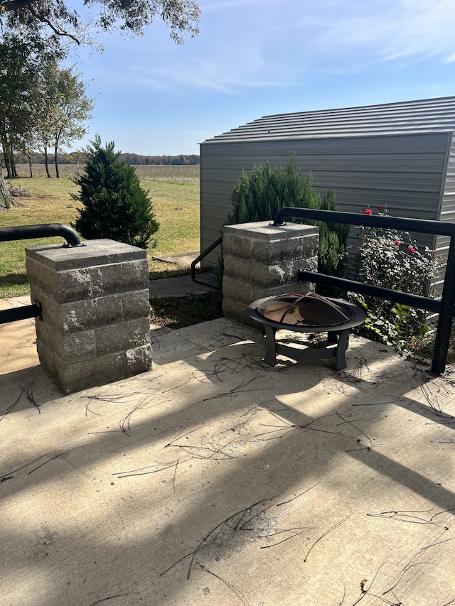 view of patio / terrace featuring an outdoor fire pit