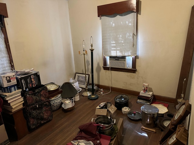 dining area with cooling unit and dark hardwood / wood-style flooring