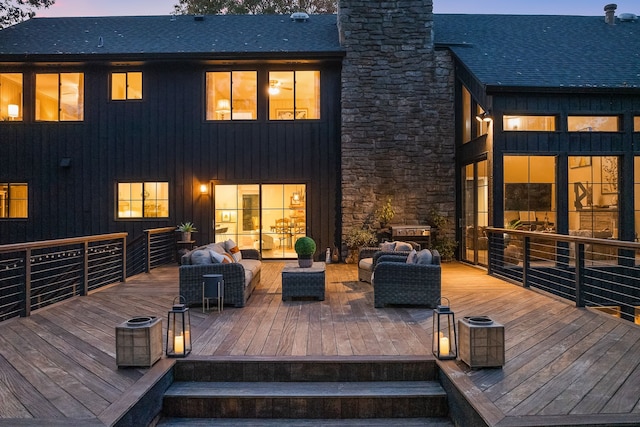 deck at dusk featuring an outdoor hangout area