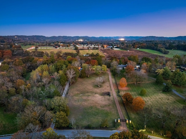 aerial view at dusk featuring a mountain view