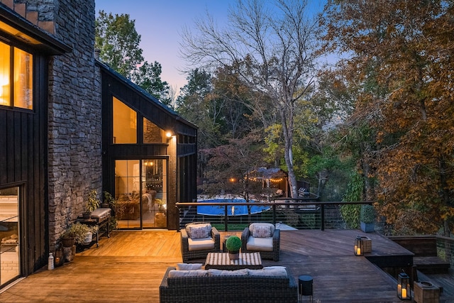 deck at dusk featuring an outdoor living space