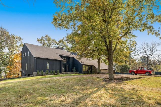 view of side of home with a yard