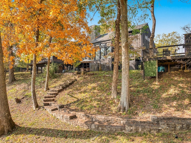 view of yard with a wooden deck and a sunroom