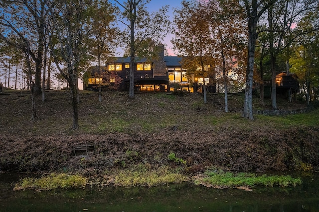 view of back house at dusk