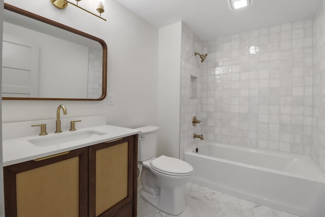 full bathroom with tiled shower / bath, vanity, and toilet