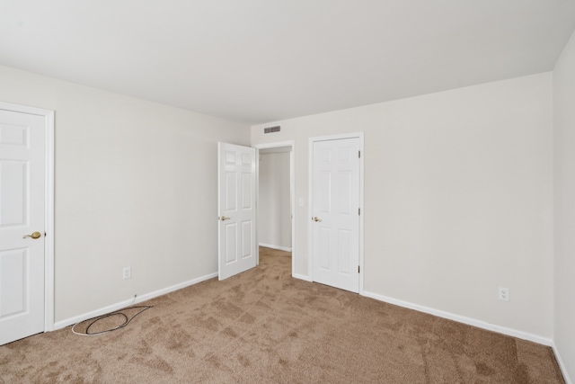 unfurnished room featuring light carpet