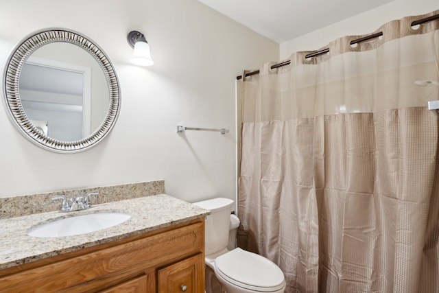 bathroom featuring vanity, toilet, and walk in shower