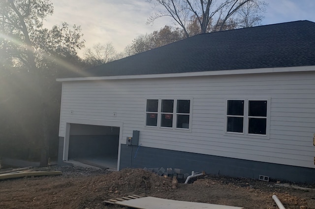 property exterior at dusk with a garage