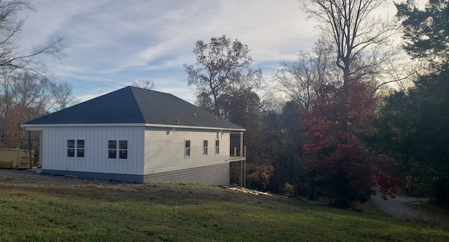 view of side of property featuring a lawn and board and batten siding