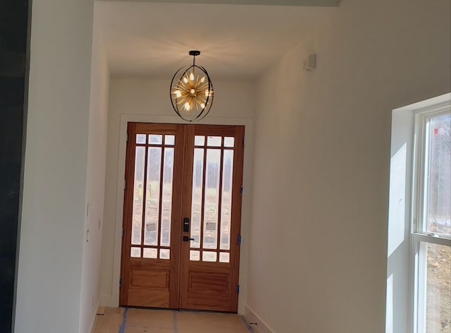 entrance foyer with a notable chandelier and french doors