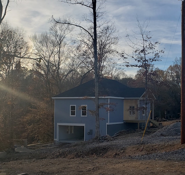 property exterior at dusk featuring a garage