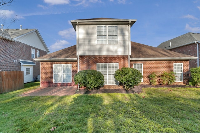 rear view of property with a lawn and a patio