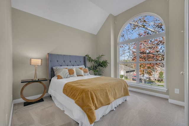 carpeted bedroom with lofted ceiling