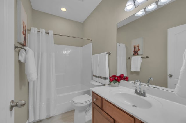 full bathroom featuring vanity, wood-type flooring, shower / tub combo, and toilet