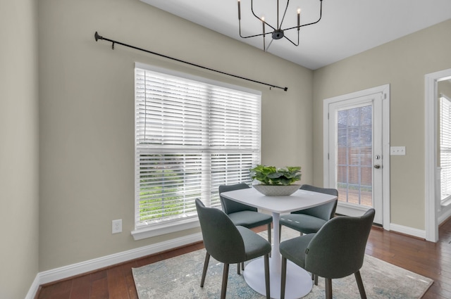 dining room with a chandelier and dark hardwood / wood-style floors