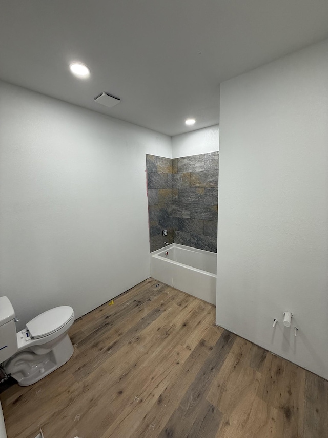 bathroom with hardwood / wood-style flooring and toilet