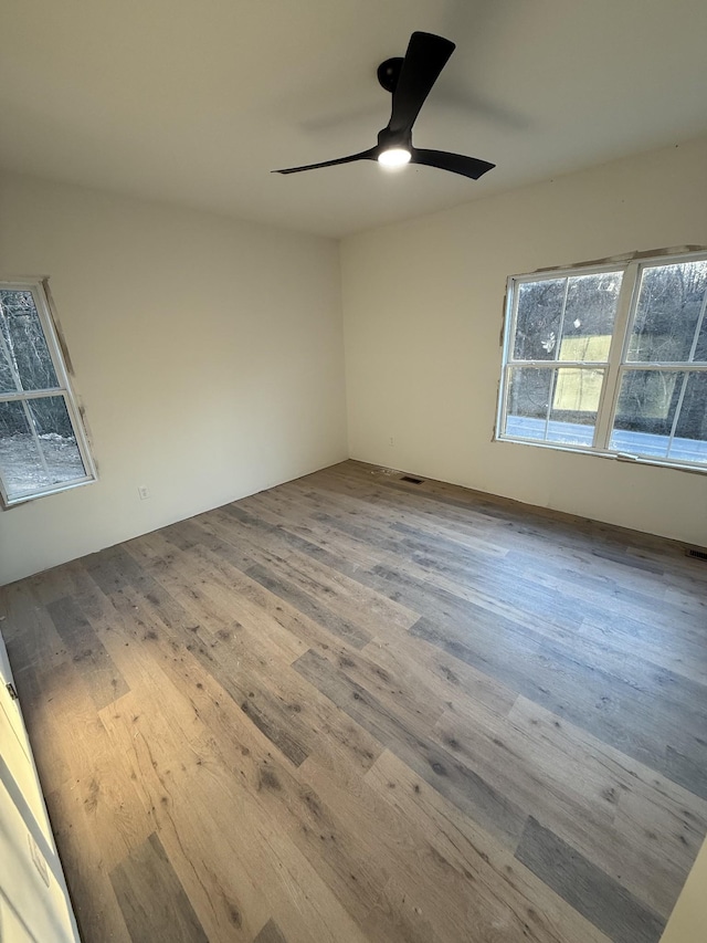 unfurnished room featuring ceiling fan and hardwood / wood-style floors