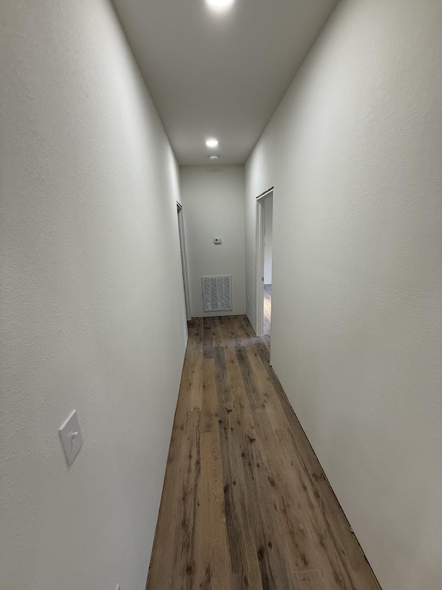 corridor with hardwood / wood-style floors