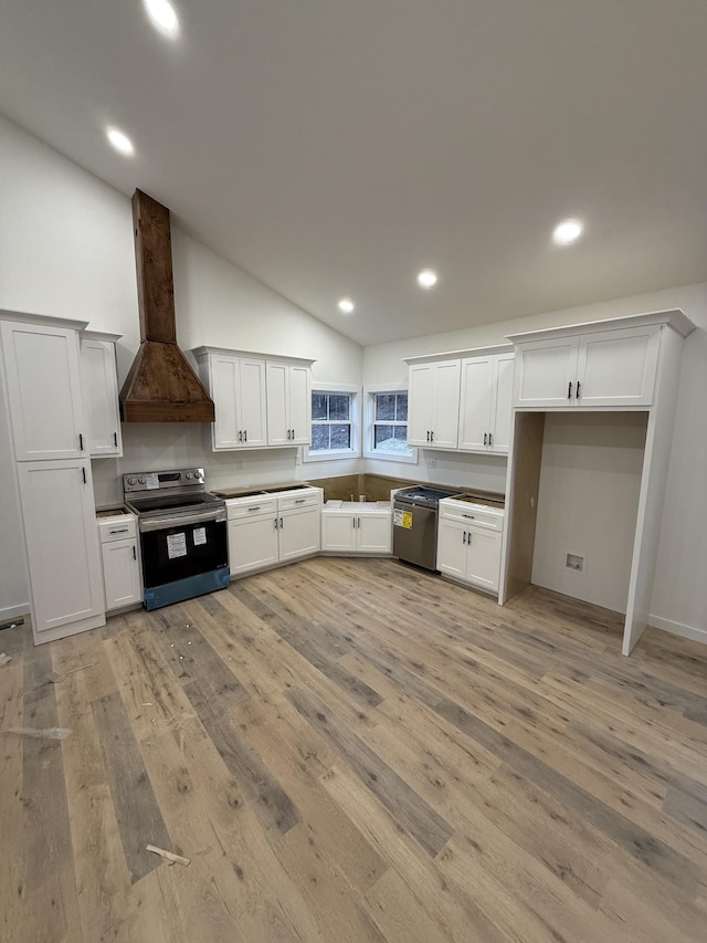 kitchen with white cabinets, custom range hood, and stainless steel appliances