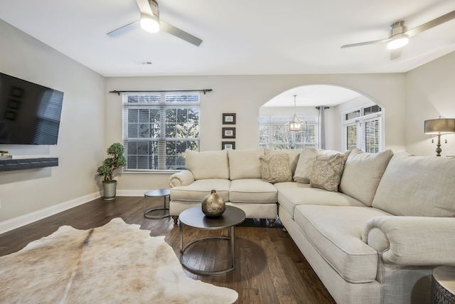 living room with dark hardwood / wood-style floors and ceiling fan