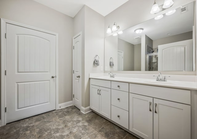 bathroom with a shower with door and vanity