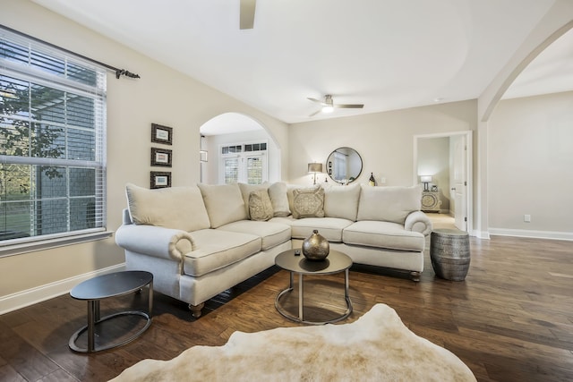 living room featuring dark hardwood / wood-style floors and ceiling fan