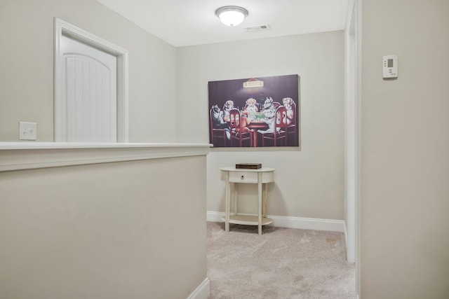 corridor featuring light colored carpet