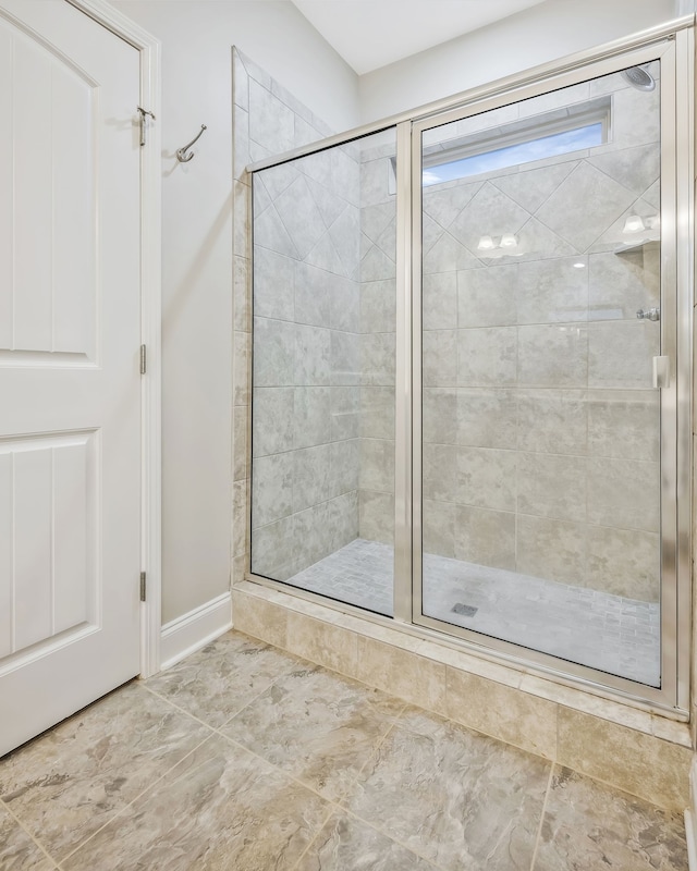 bathroom featuring a shower with door